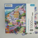 Steep hill with multi-colored homes by the sea