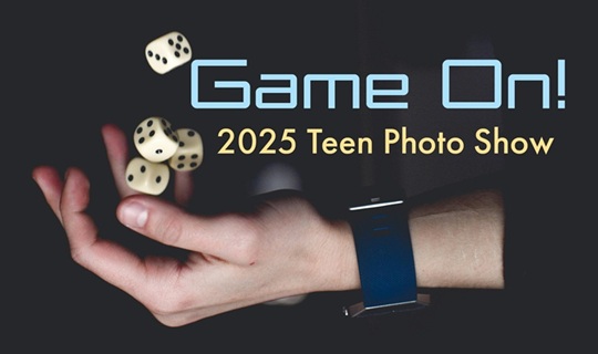 Young man's hand tossing dice into the air.