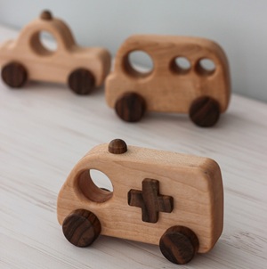 Wooden vehicle set including an ambulance, a bus, and a taxi.