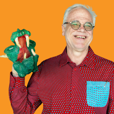 Thaddeus Jurczynski holding a Dragon hand puppet