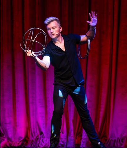 Brian Ledbetter Doing a Stage trick with several hoops