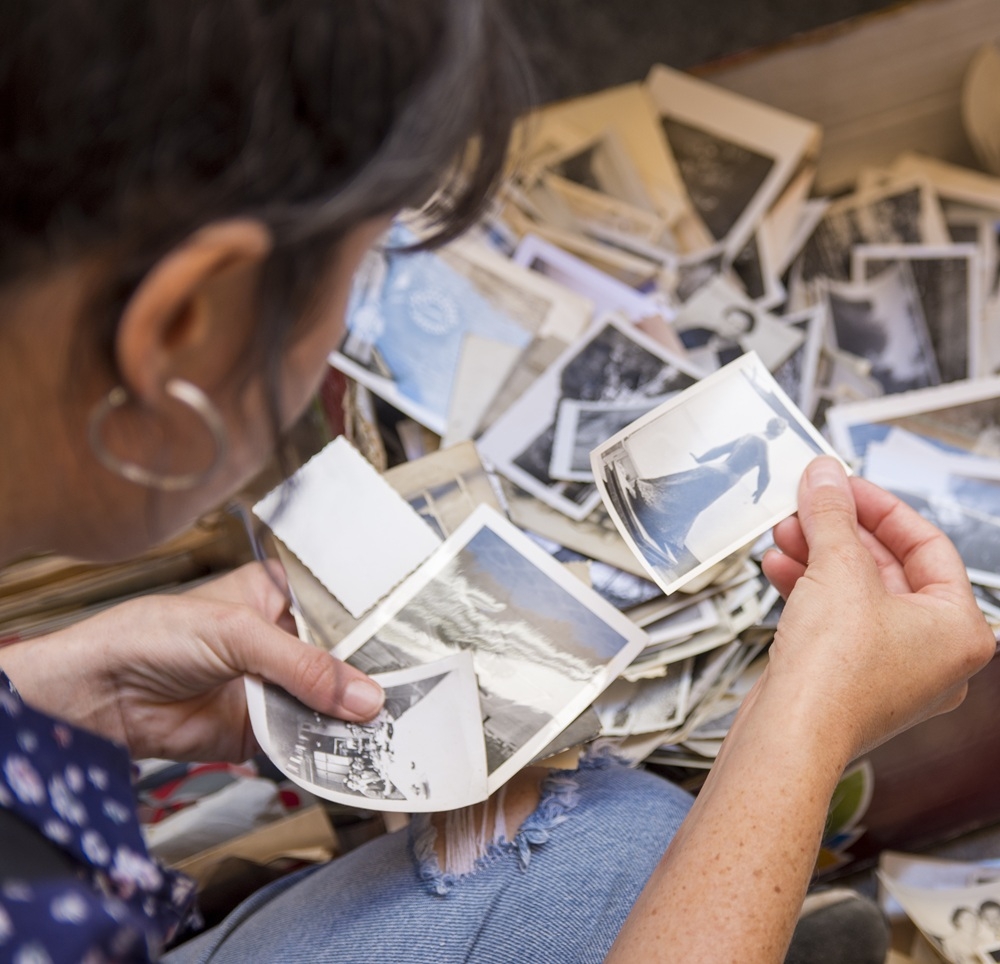 A woman looks through old photos.