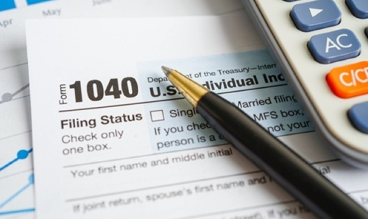 Tax forms with pen and calculator.