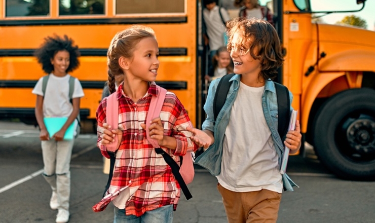 Kids getting off of a School Bus
