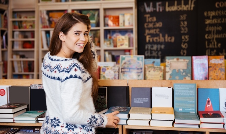 A woman shops for books.